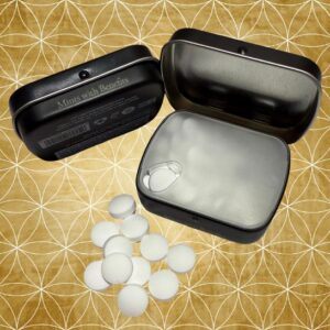 Open IntenseMints™ tin with fresh white peppermint mints spilling onto a gold geometric background featuring the Flower of Life pattern.